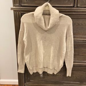 Super soft beige sweater with fabric line down front and back.